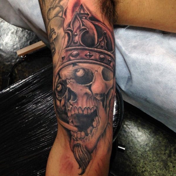 Ogling Skull With Crown Tattoo On Upperarms For Guys