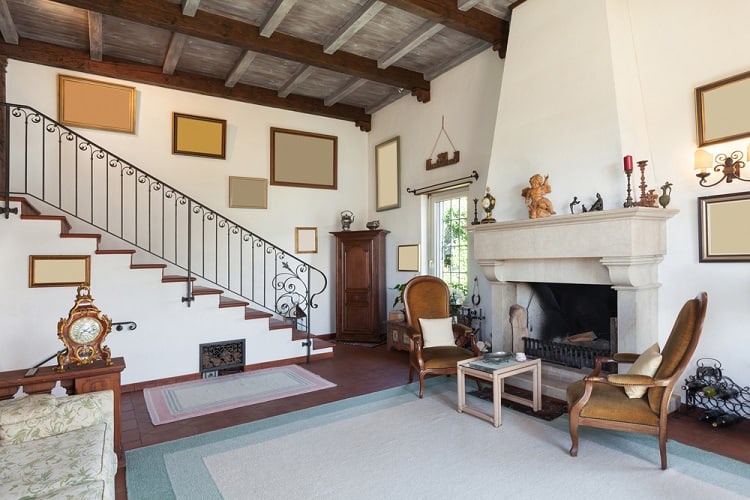 country style living space with large ornate fireplace