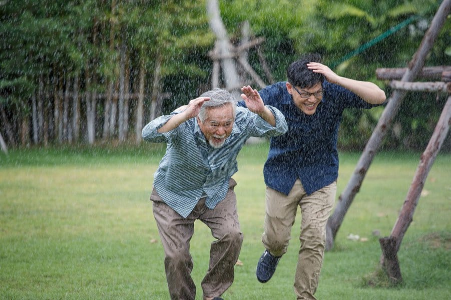 old man and young man running from the rain
