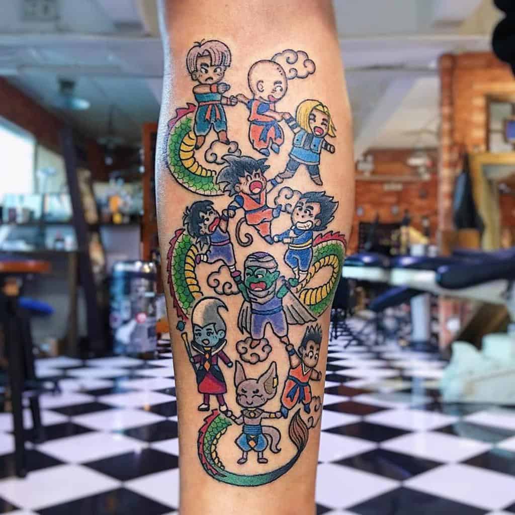 A colorful Dragon Ball tattoo featuring several characters, including Trunks, Krillin, Goku, Piccolo, and others, arranged around a dragon with clouds and vibrant colors.