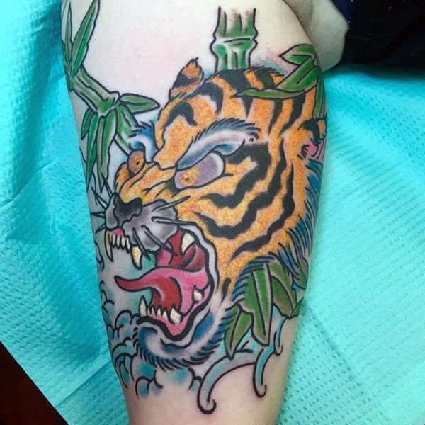 Old School Roaring Japanese Tiger With Bamboo And Ocean Waves Tattoo For Guys