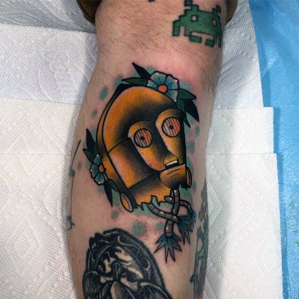 Neo-traditional C-3PO tattoo with bold outlines, vibrant colors, floral accents, and exposed wires, blending sci-fi with classic tattoo artistry.