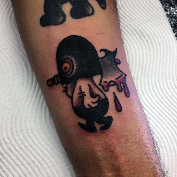 Cartoon-style executioner tattoo featuring a small hooded figure with a glowing red eye, carrying a bloodied axe, in bold black and red ink.