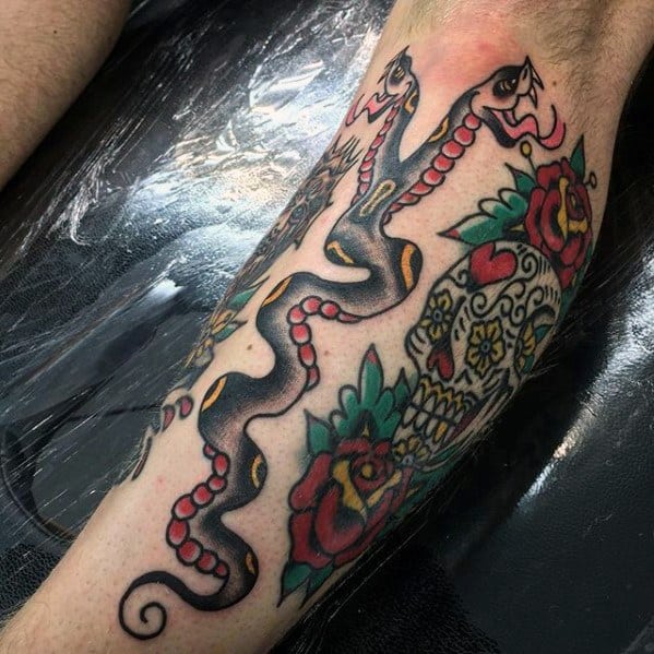 Two-headed snake tattoo with bold black and red tones, intertwined with a colorful sugar skull and roses for a vibrant and striking design.
