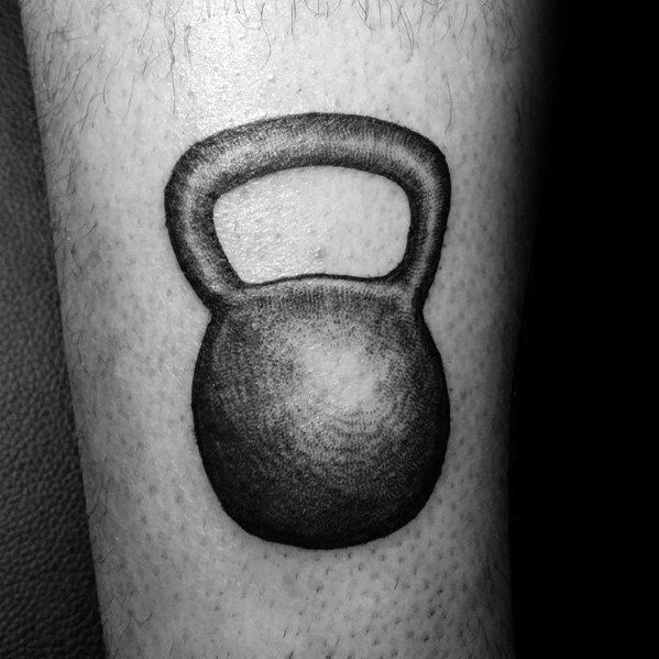Realistic black and gray kettlebell tattoo on the forearm, symbolizing strength, endurance, and dedication to fitness and CrossFit training.