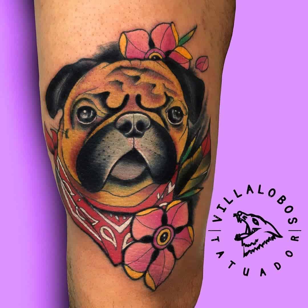 Tattoo of a pug wearing a red bandana surrounded by pink flowers and leaves