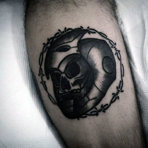 Iron Man tattoo featuring a unique design combining a skull with the outline of Iron Man's helmet, creating a bold contrast in black ink with intricate detailing.