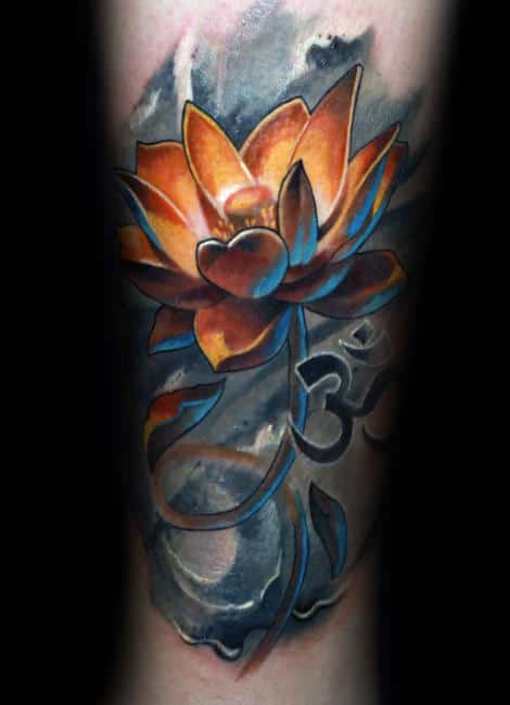 Tattoo of an orange lotus with blue highlights and an Om symbol on a smoky black and gray background