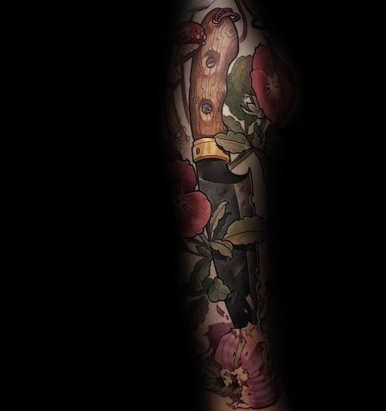 Detailed tattoo sleeve featuring a rustic knife surrounded by onions, flowers, and foliage, blending realism with traditional tattoo shading and colors.