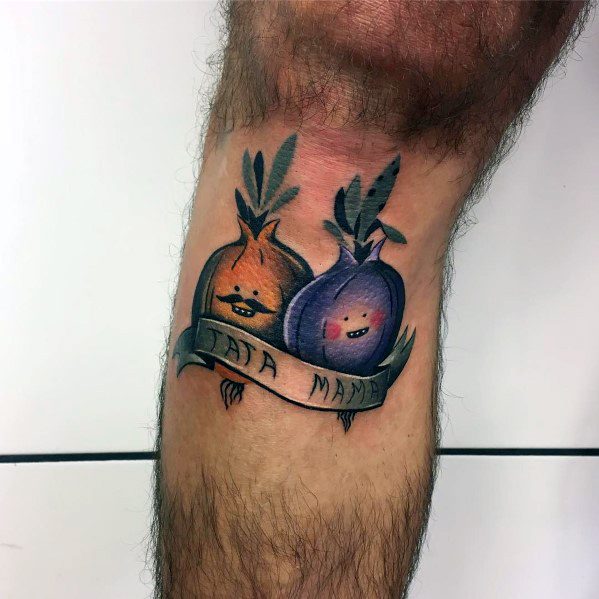 Playful tattoo of two smiling onions, one orange and one purple, with a banner reading "TATA MAMA," featuring bold outlines and soft shading.