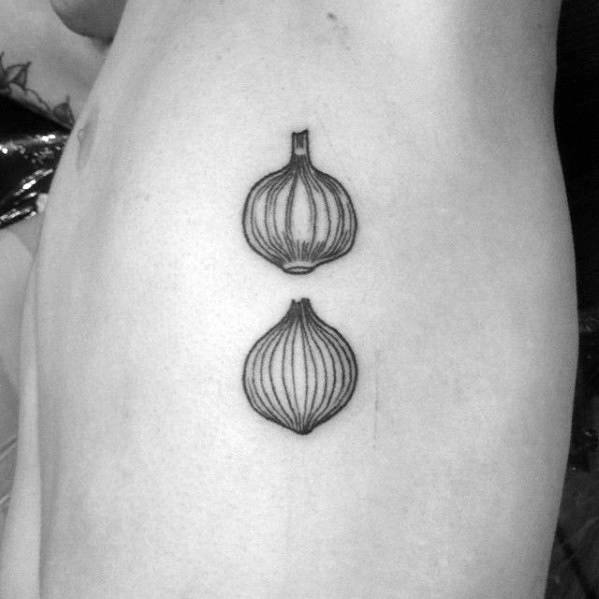 Minimalist black ink tattoo of two onions stacked vertically on the upper arm, featuring fine line details and a simple, clean design.