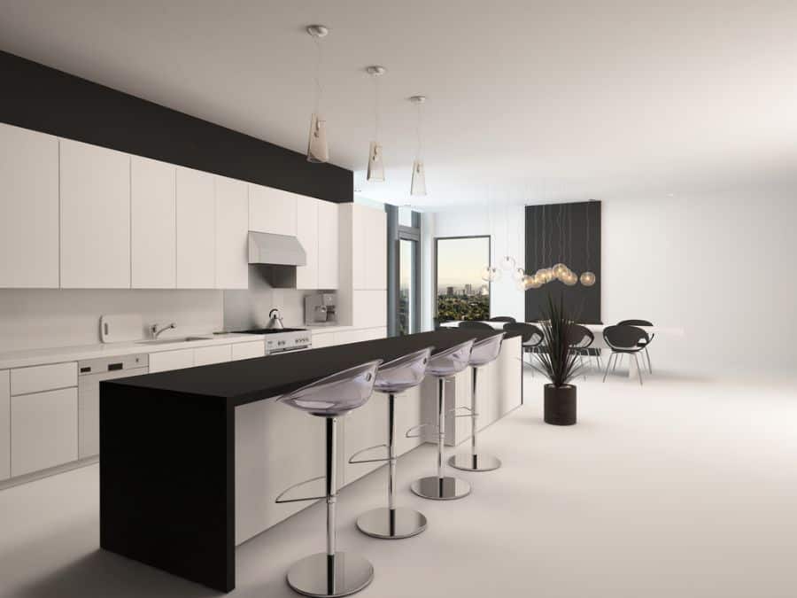 Minimalist kitchen with white cabinets, black island, modern bar stools, and open dining area.