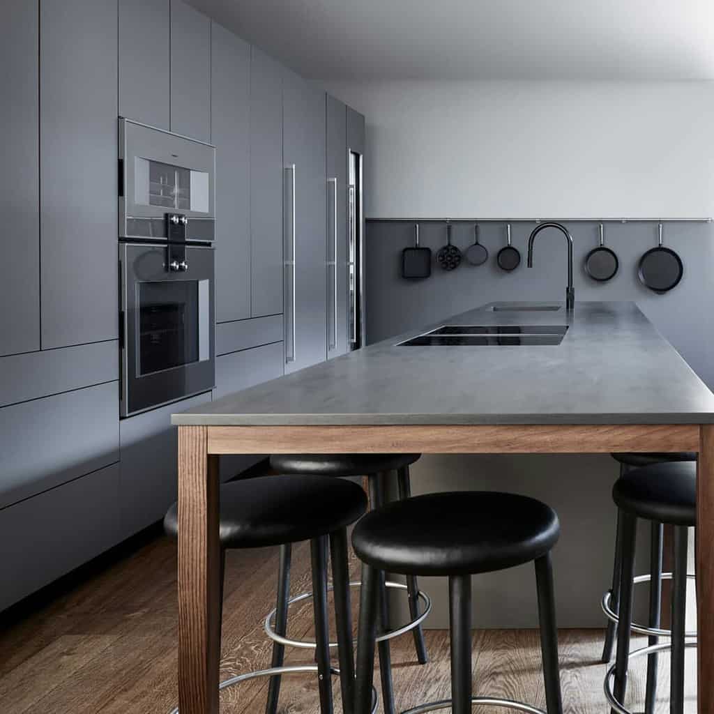 modern open layout galley kitchen gray cabinets and cupboards island hanging pots and pans
