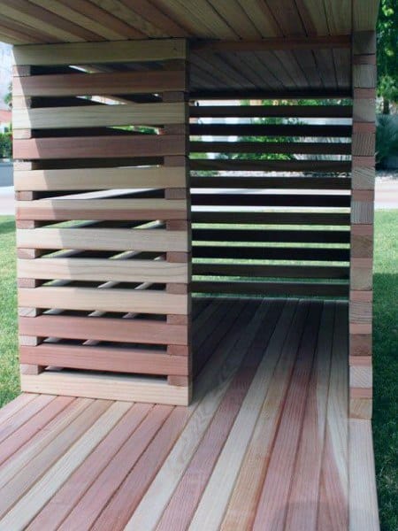 Dog-friendly wooden house with open slatted design, allowing light to pass through