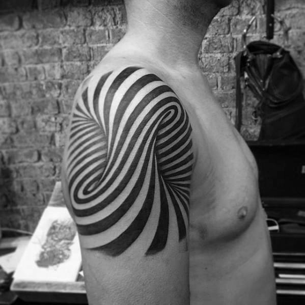 Black and white tattoo of swirling stripes on a person's shoulder and upper arm