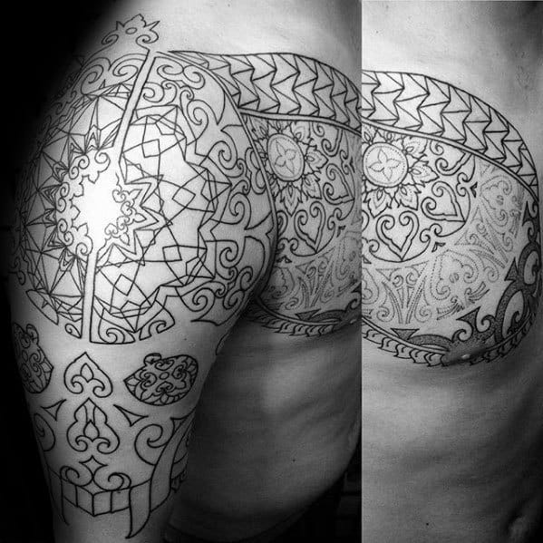 Large geometric and tribal-style tattoo on the hip and thigh, featuring intricate patterns, mandalas, and symmetrical linework.