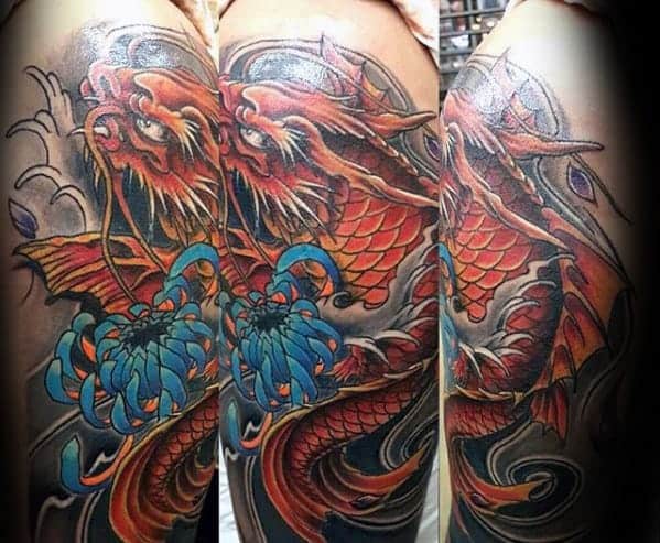 Colorful dragon tattoo with blue flowers on an arm