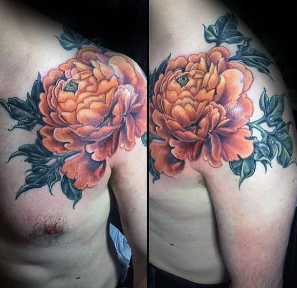 Tattoo of a large orange peony with green leaves on a person's upper arm and shoulder