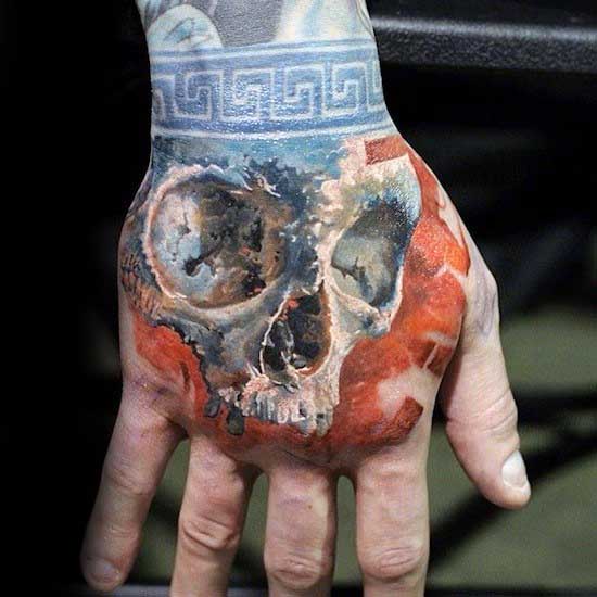 Orange With Blue Wrist Band Mens Skull Hand Tattoo Designs