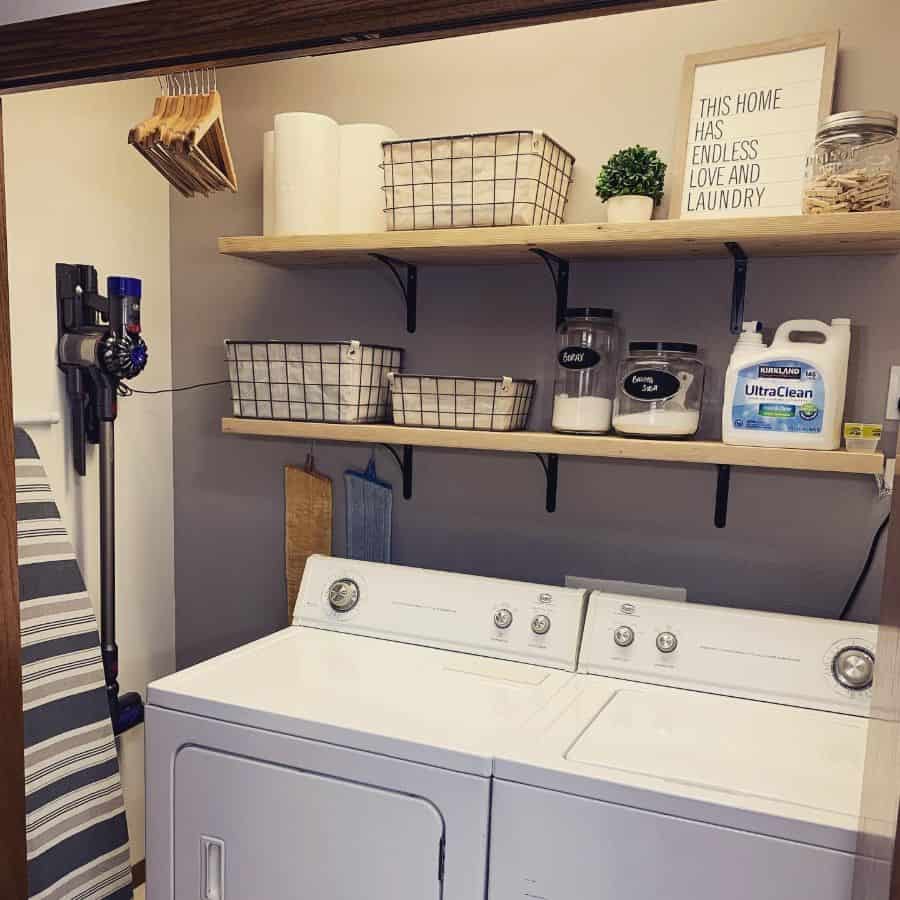 wall shelves in small laundry with washer and dryer
