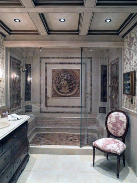 Luxurious bathroom with a sleek shower, ornate wall art, detailed ceiling, and an upholstered chair