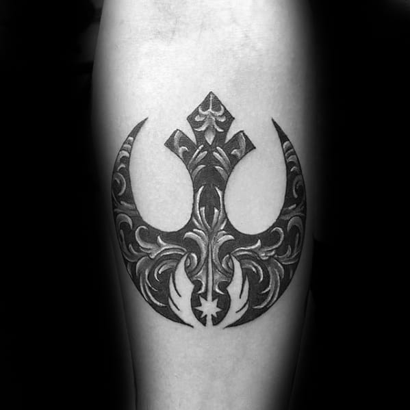 Rebel Alliance tattoo on the forearm with intricate black and gray floral patterns filling the symbol.