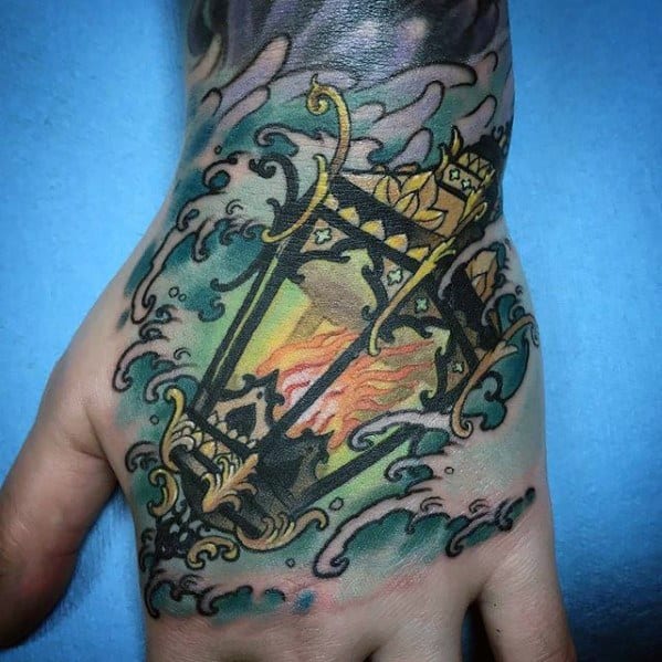 Ornate Hand Ocean Waves Lantern Tattoo Design On Man