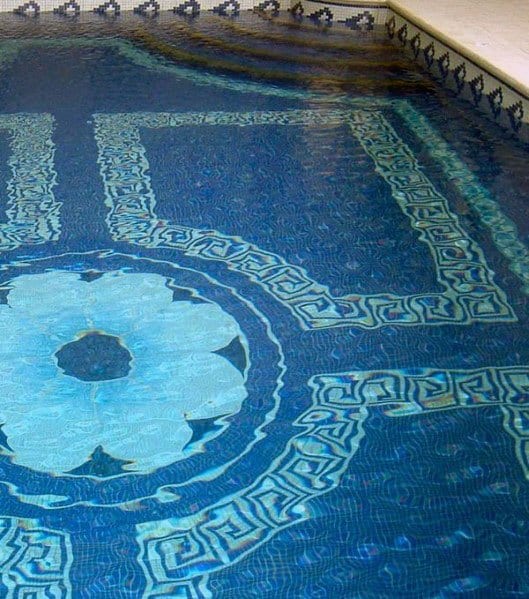 Ornate pool design with intricate blue mosaic tiles featuring floral and geometric patterns.