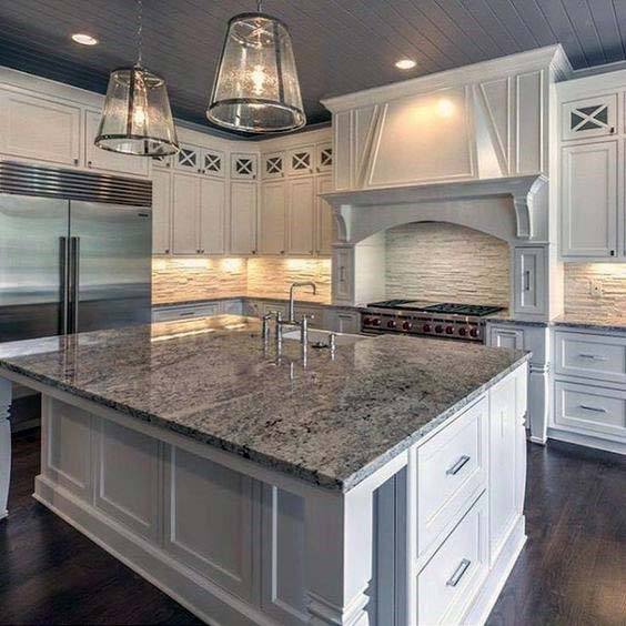 full wide white kitchen with ornate hood