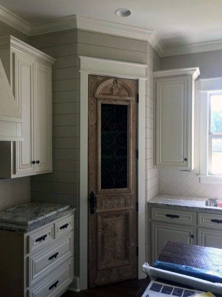 small ornate wood kitchen pantry door 