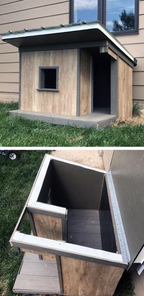 Outdoor dog house with a hinged roof design for easy access, featuring wooden walls and a small window, set in a grassy area