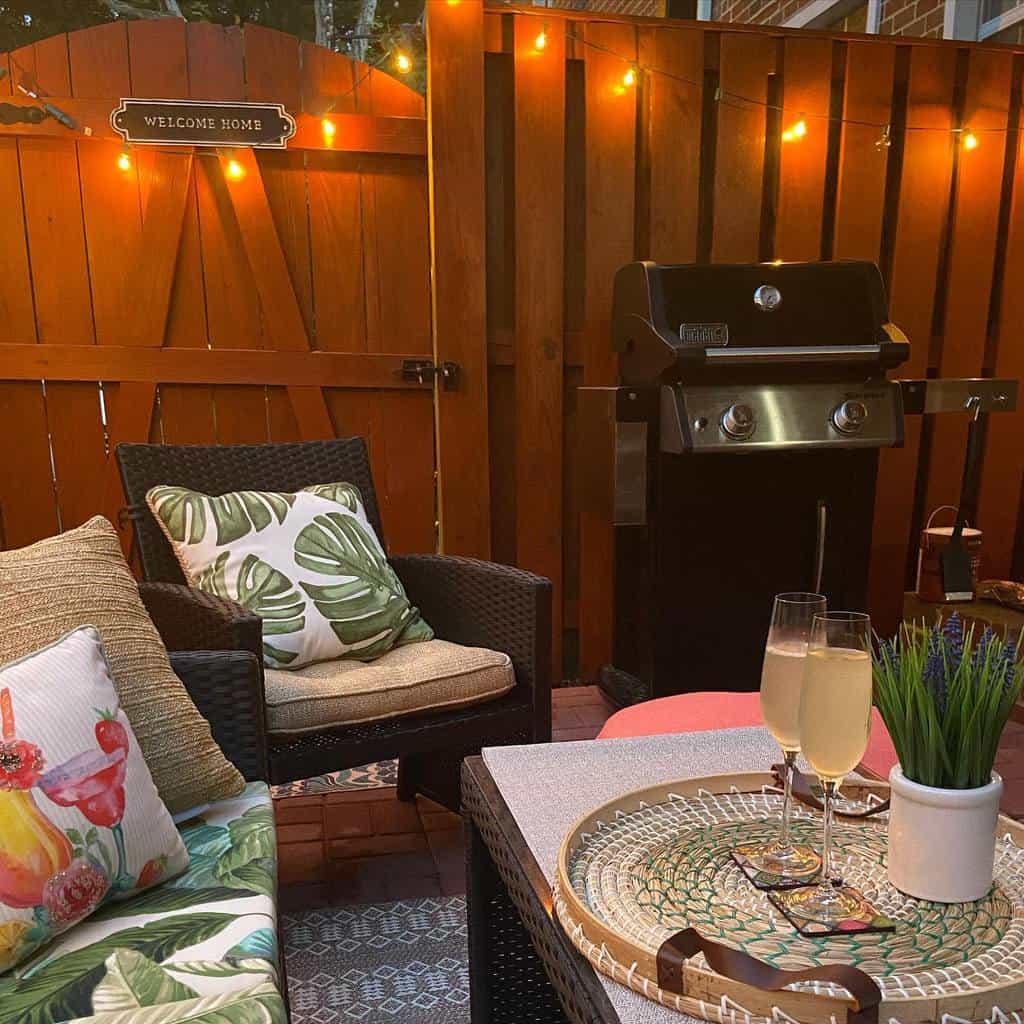 small outdoor patio with bbq and seating