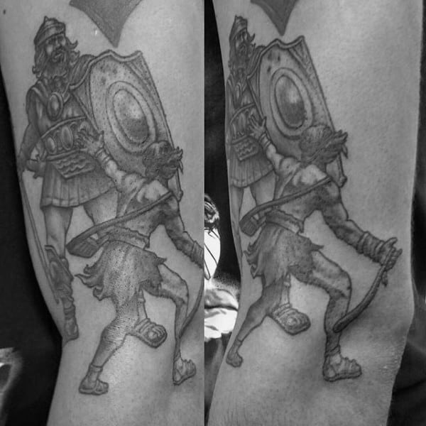 Outer Arm Tattoo Of David And Goliath On Man