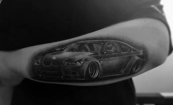 Realistic BMW M3 tattoo on forearm, featuring bold shading and fine details for a sleek and dynamic automotive-inspired design.