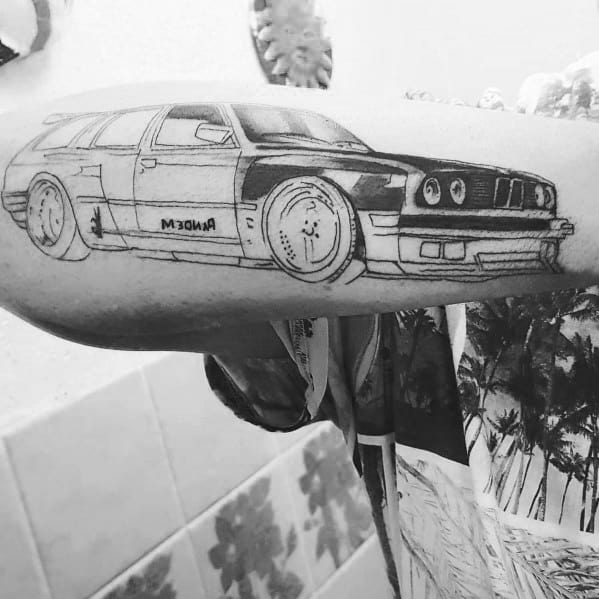 Detailed BMW E30 wagon tattoo on forearm, featuring a sketched design with bold lines and shading for a dynamic, custom-car look.