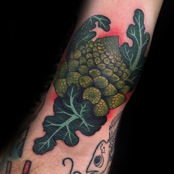 Detailed Romanesco broccoli tattoo with bold shading and rich green tones, creating a striking and realistic botanical design on the forearm.