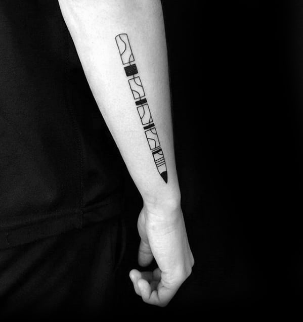 Forearm tattoo of an abstract, geometric design resembling a pencil on a person wearing a black shirt