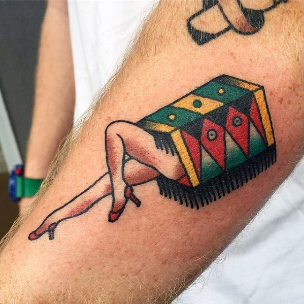 Tattoo of a magician's box with a pair of legs in red heels playfully emerging from it
