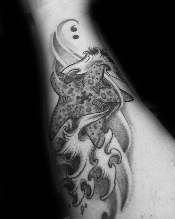 Black and grey starfish tattoo on the forearm with swirling ocean waves and soft shading, blending realism and abstract flow.