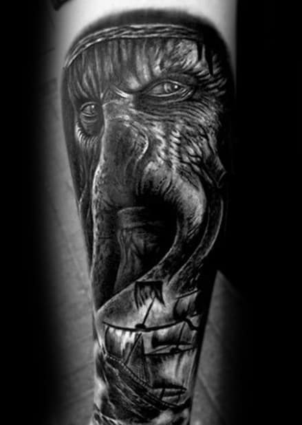 Black and gray tattoo of Davy Jones' detailed face on a person's forearm