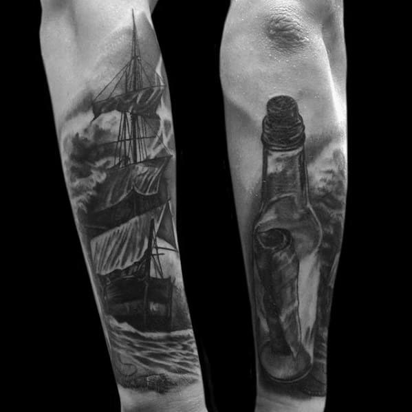 Forearm tattoos of a ship in stormy seas and a classic message in a bottle