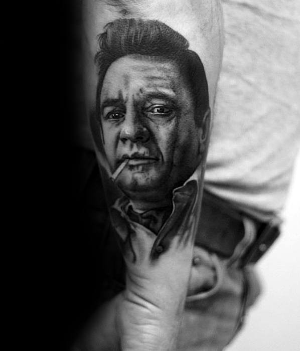 Black and white tattoo of Johnny Cash with a cigarette on an arm