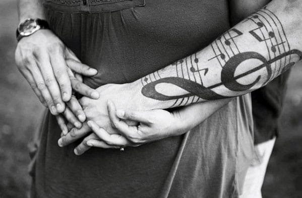 Outer Forearm Male Tattoo With Music Staff Design