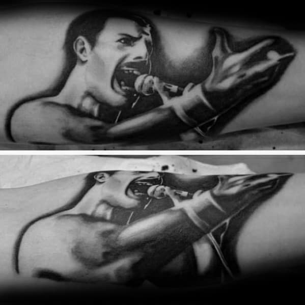 Dramatic black and grey tattoo of Freddie Mercury mid-performance, with expressive hand gesture and powerful facial intensity.