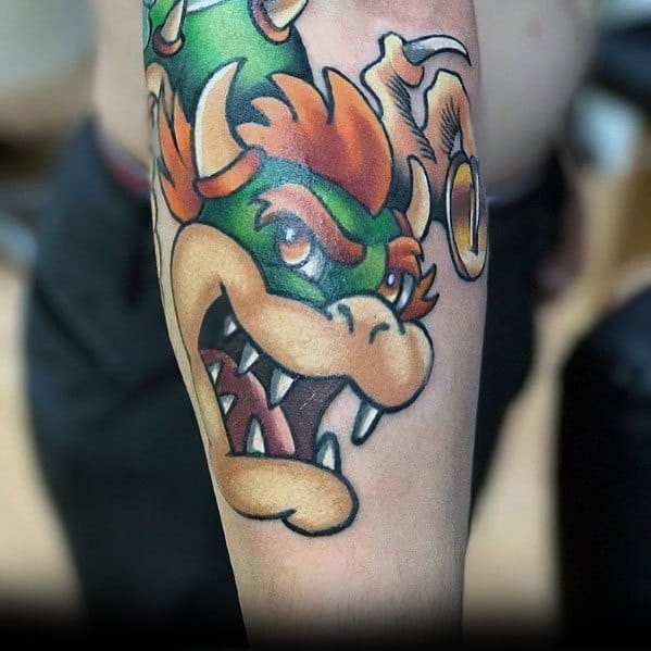 Bold Bowser tattoo on a man's forearm featuring vibrant colors, strong outlines, and a fierce expression for a striking Mario-inspired design.