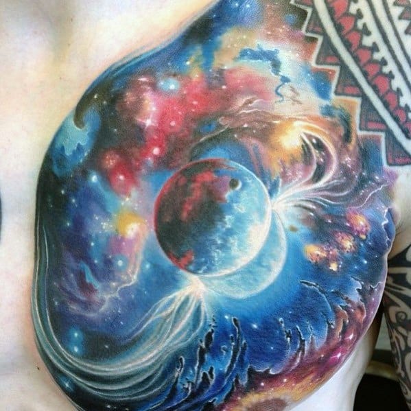 Chest tattoo featuring a colorful cosmic scene with planets, swirling galaxies, and an abstract nebula pattern