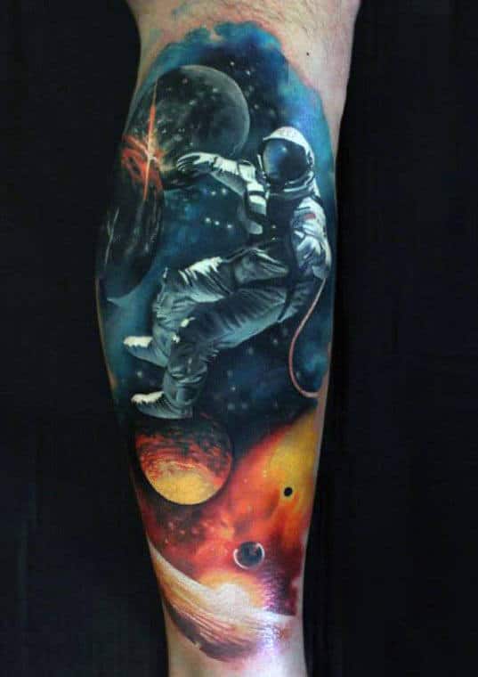 Tattoo of an astronaut floating in space with planets and celestial backgrounds