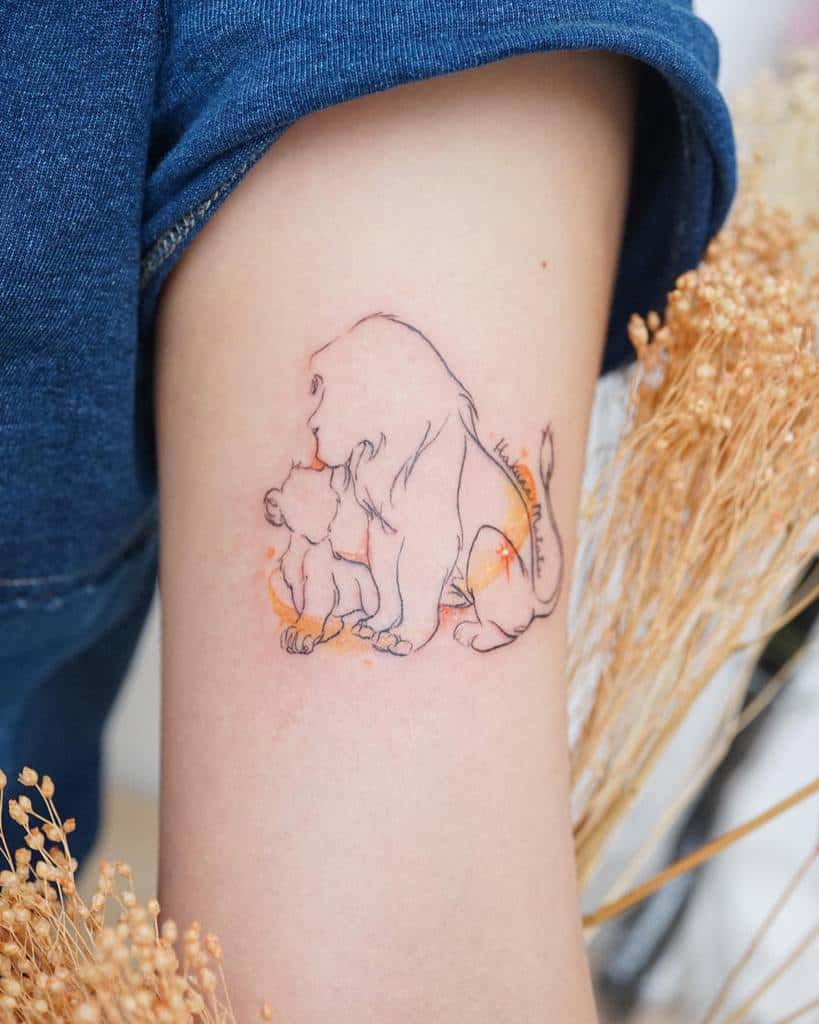 Minimalist tattoo of Mufasa and Simba, with subtle orange highlights and clean line work, has "Hakuna Matata" on the side
