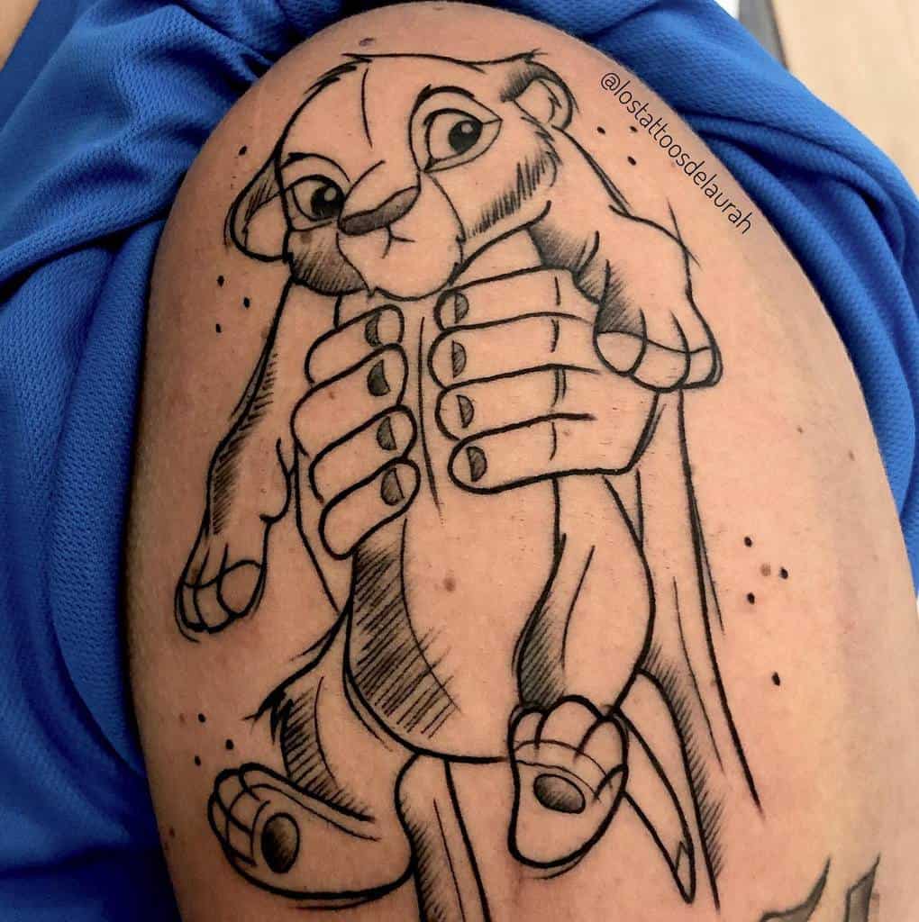 Black and white tattoo of Rafiki holding up Simba as a cub, capturing the iconic moment with detailed lines and shading