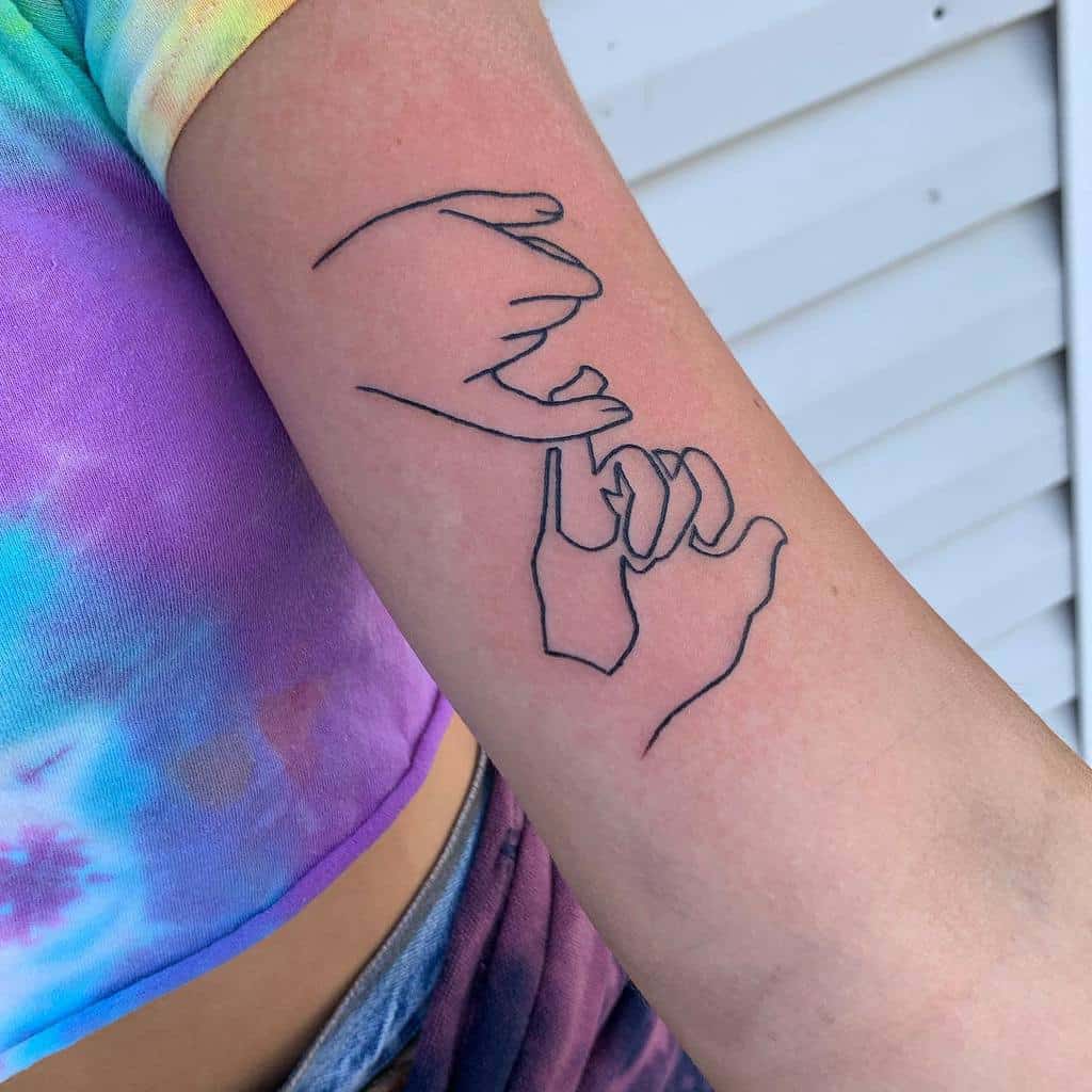 Minimalist pinky promise tattoo with fine black line art on the forearm, featuring two hands linking fingers in a simple design
